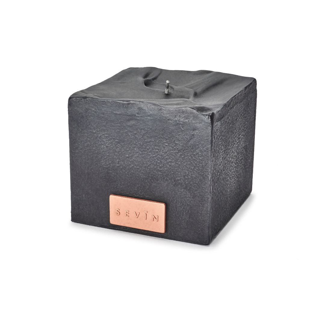 Marble Black cube-shaped product with a copper label on a white background