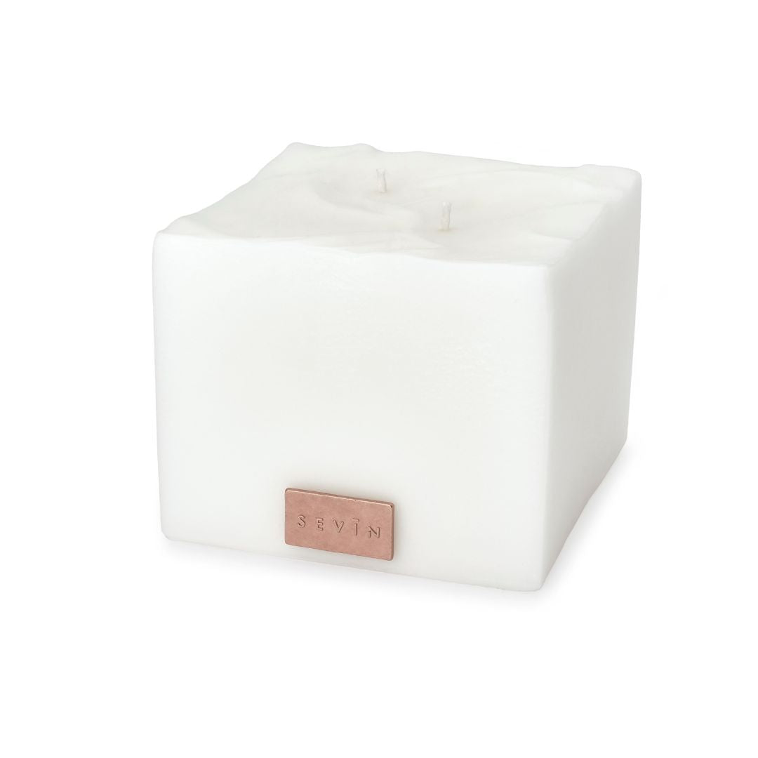 White cube-shaped candle with a rose gold label on a white background - Porcelain White Scented Candle