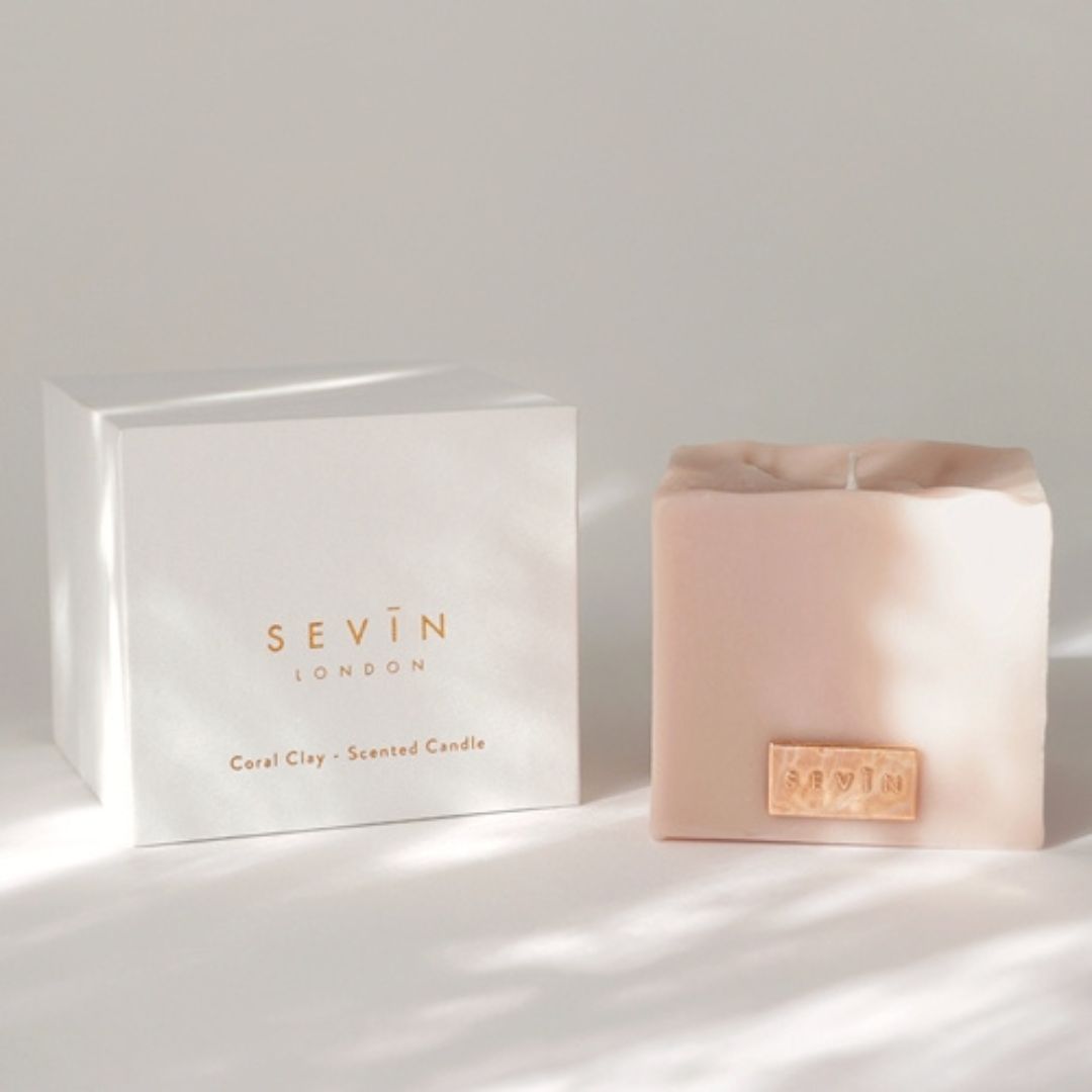 Candle and packaging with 'Sevin London' branding on a light background