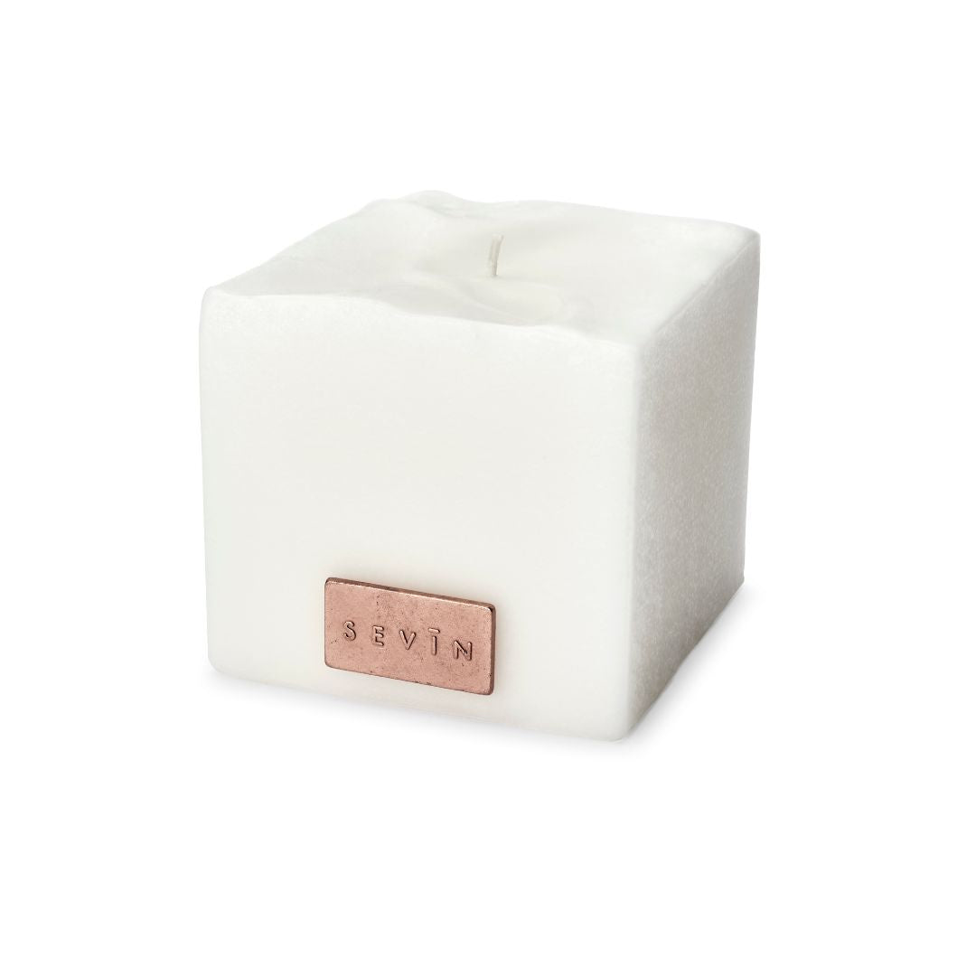 White cube-shaped candle with a rose gold logo on a white background - Porcelain White Scented Candle
