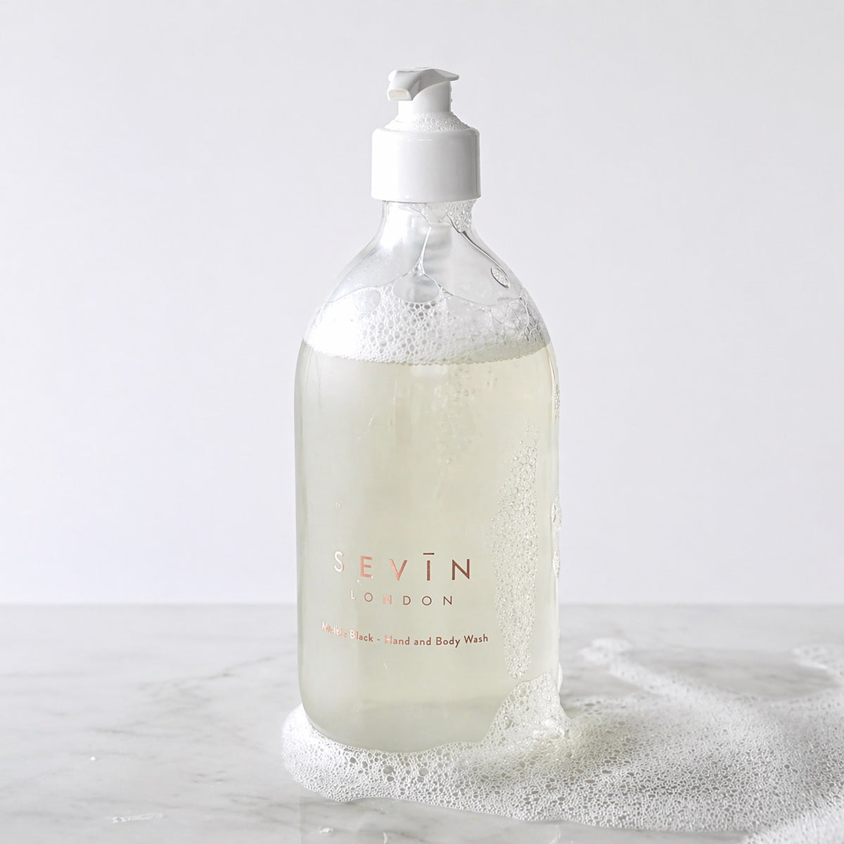 Bottle of Sevin marble black hand & body soap with pump on a white background