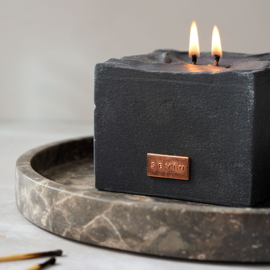 Black candle with a copper brand logo SEVIN London on a marble tray - Marble Black scented can candle